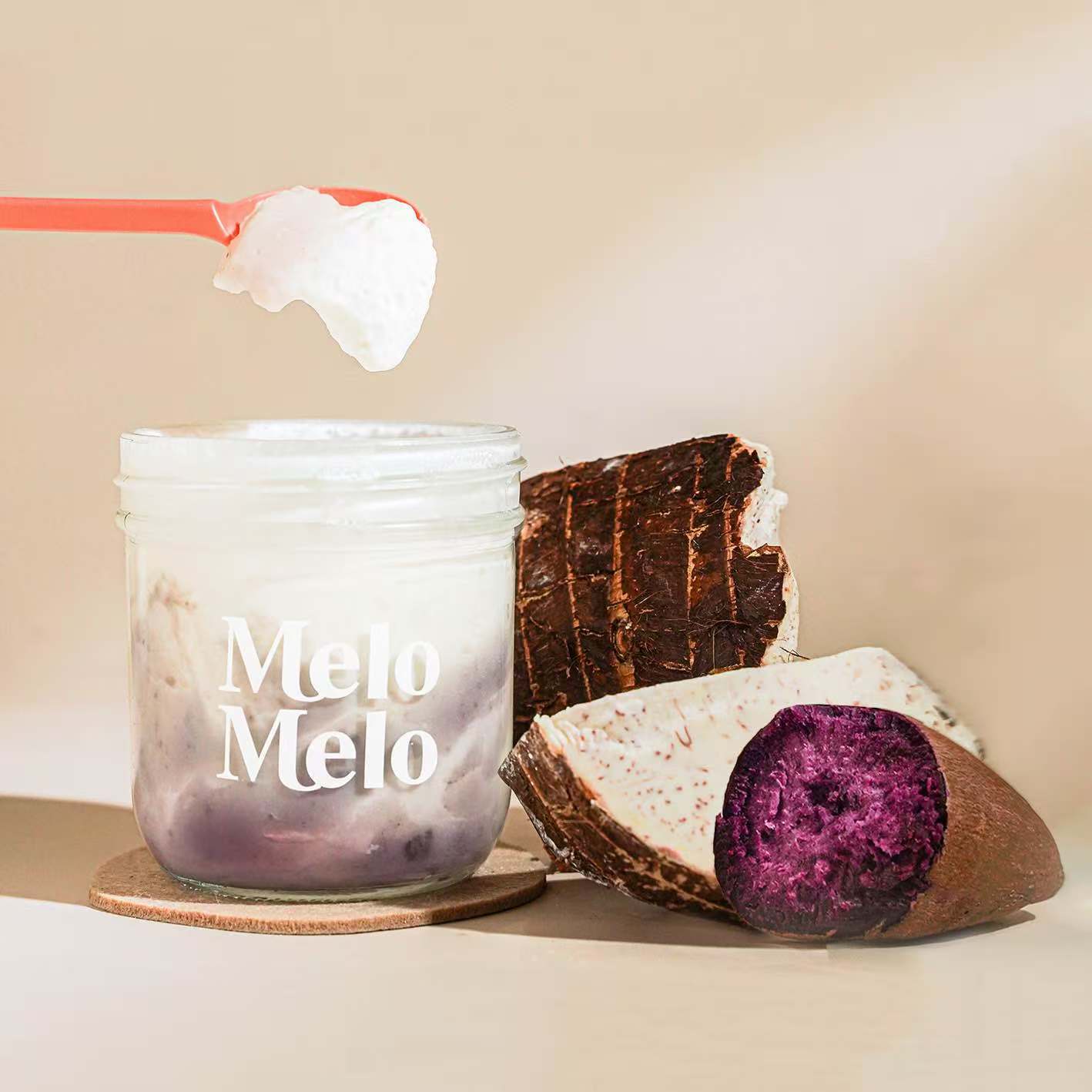 Taro Ube coconut jelly in glass jar, creamy coconut layer with taro and ube paste base, spoon lifting silky jelly, dripping texture, fresh Taro  beside, clean beige background, soft natural light, premium food photography