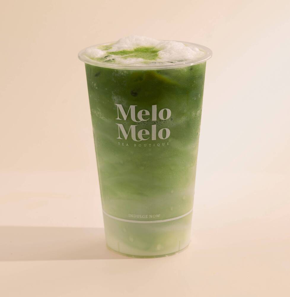 Matcha latte with Australian imported creamy milk, and vibrant green matcha, topped with fresh fruit in a Melo Melo cup.