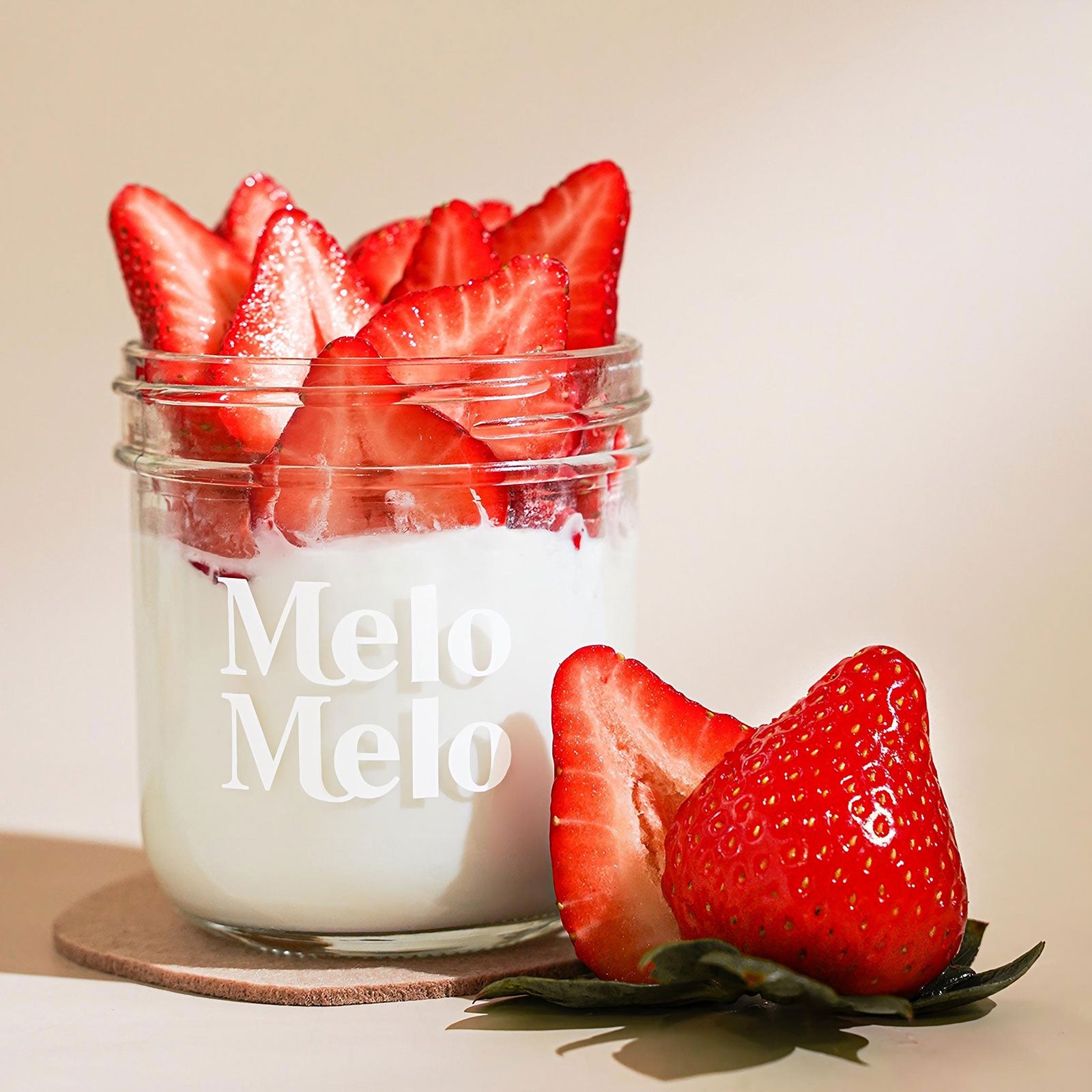 Strawberry coconut jelly in glass jar, creamy coconut layer with chunky Strawberry, fresh Strawberry beside, clean beige background, soft natural light, premium food photography