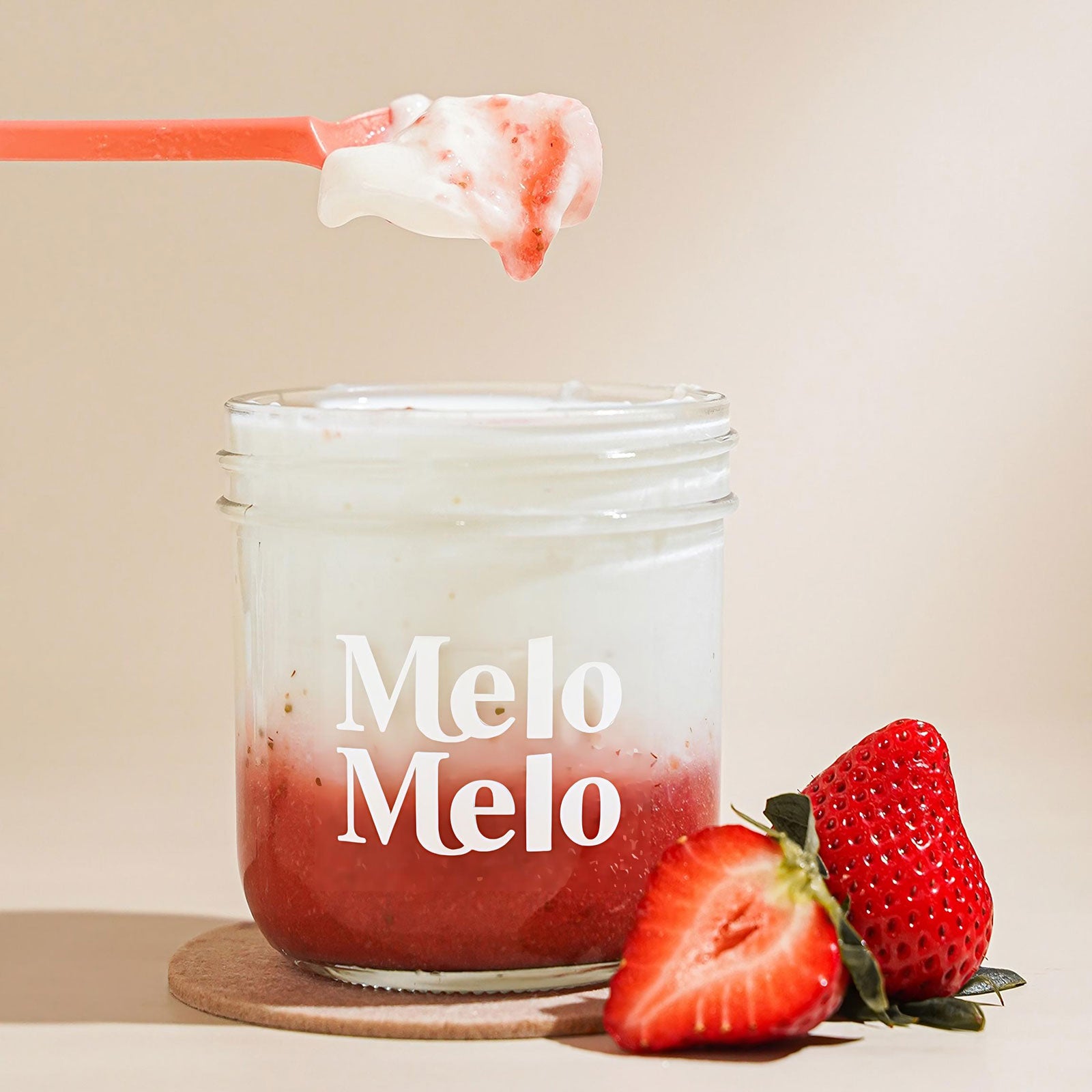 strawberry coconut jelly in glass jar, creamy coconut layer with strawberry puree base, visible strawberry pieces, spoon lifting silky jelly, dripping texture, fresh strawberries beside, clean beige background, soft natural light, premium food photography